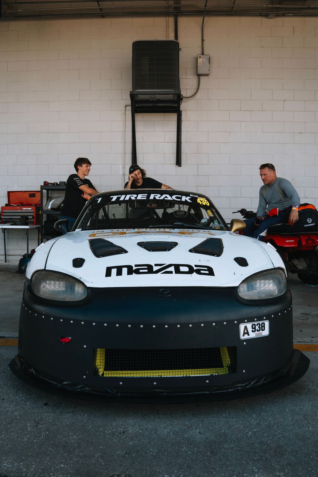 The #930 head-on in the Sebring garage, splitter and brake ducts visible.