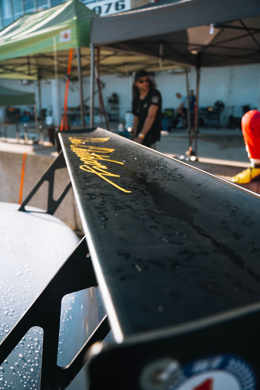 Rain beaded across the rear wing.